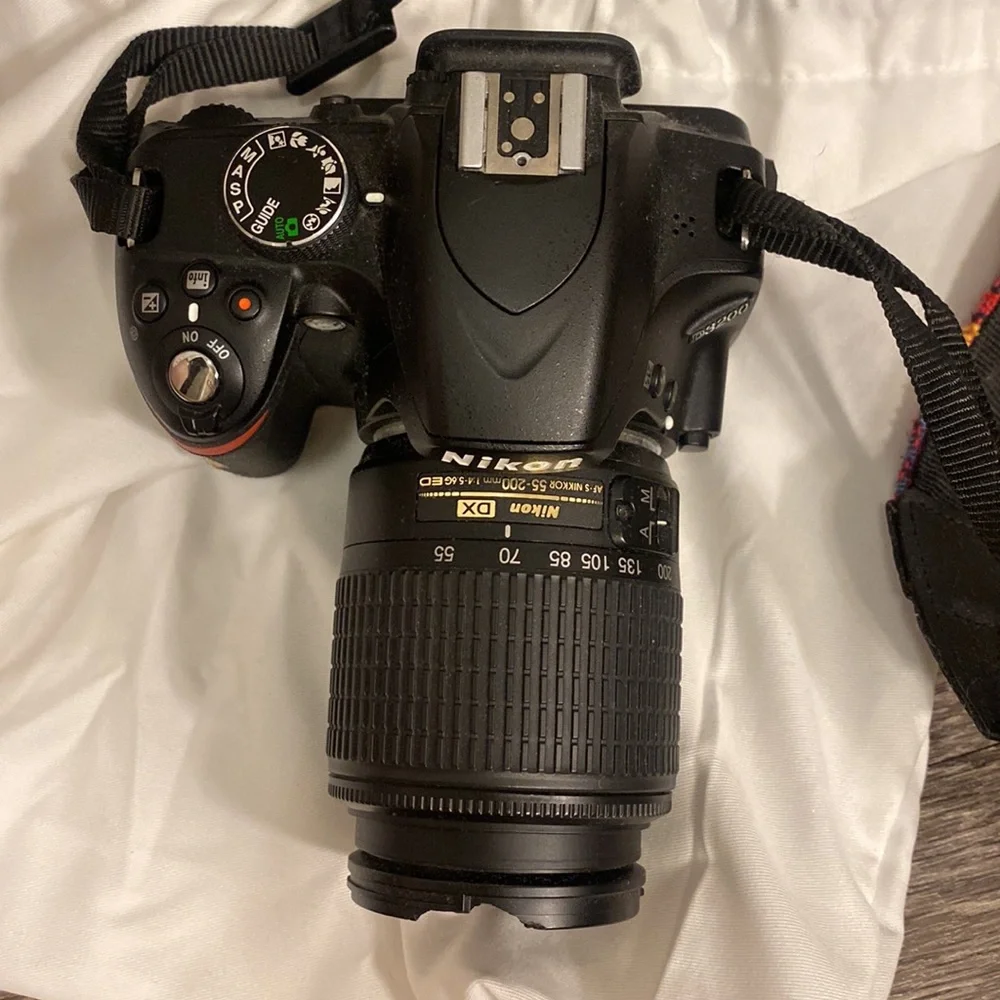 Nikon D3200 camera with battery pack and 55-200 mm lense